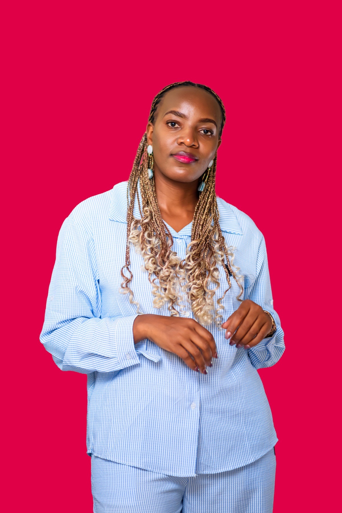 Woman in a blue striped outfit against a red background