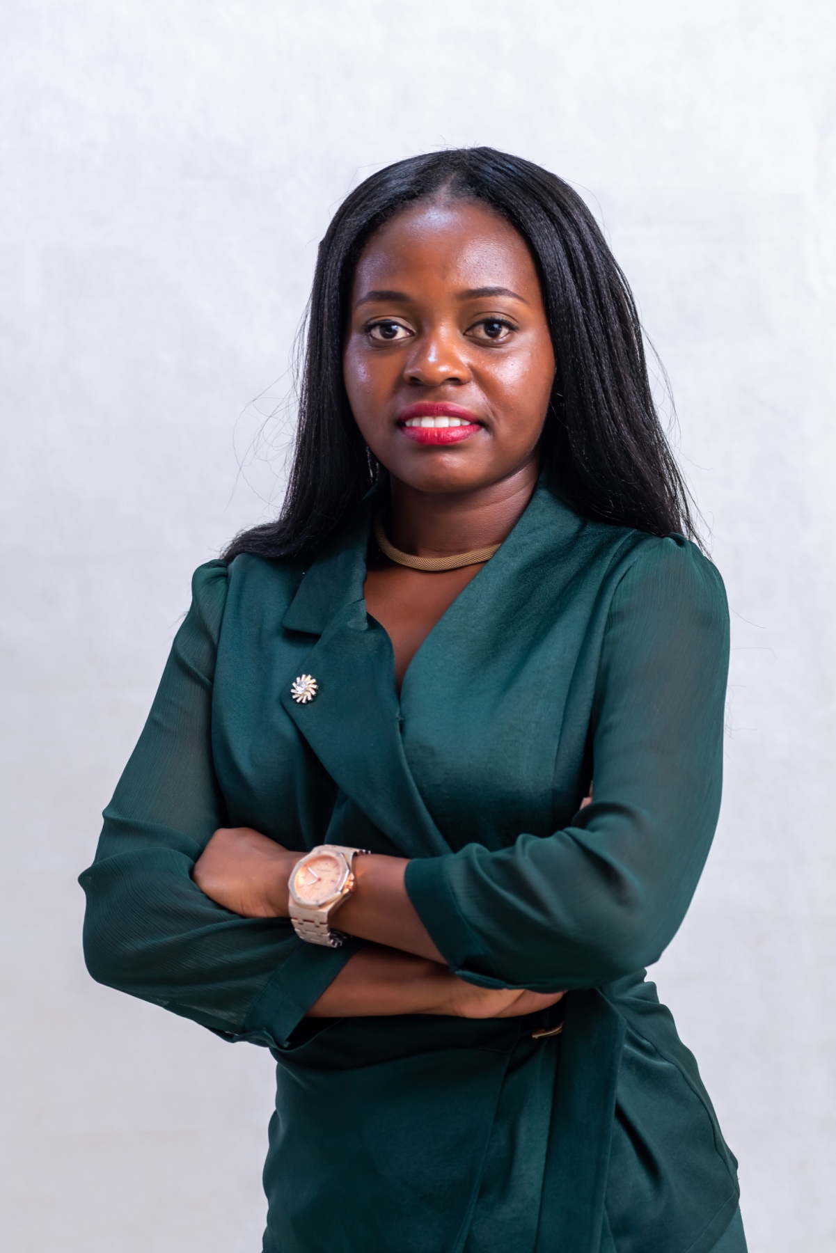 Businesswoman in a green suit with her arms crossed