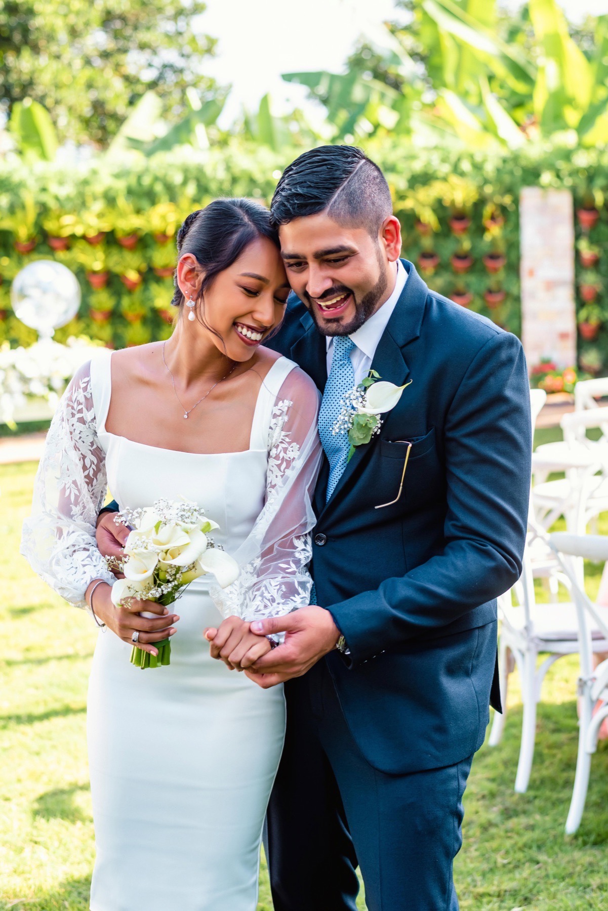Newly married couple sharing a joyful moment outdoors
