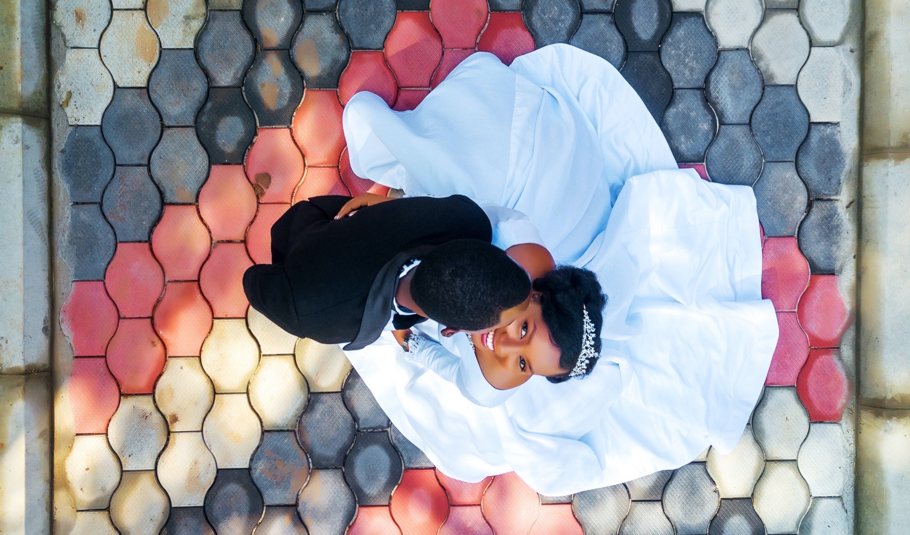 Overhead wedding portrait of a couple on patterned paving